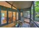 Enclosed patio with comfortable seating, overlooking a serene outdoor space, and connected to the dining room at 3270 Leslie Ne Ct, Atlanta, GA 30345