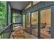 Relaxing screened porch with an outdoor table and view to the living room at 3270 Leslie Ne Ct, Atlanta, GA 30345