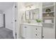 Clean bathroom featuring a modern vanity, sleek mirror, and built-in shelving for storage at 3992 Camden Way, Alpharetta, GA 30005