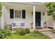 Cozy front porch with bench seating, beautiful plants and charming curb appeal at 3992 Camden Way, Alpharetta, GA 30005