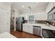 Bright kitchen features stainless steel appliances, white cabinets, and hardwood floors at 3992 Camden Way, Alpharetta, GA 30005