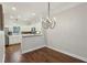 Open-concept kitchen and dining area with stainless steel appliances and modern lighting at 3992 Camden Way, Alpharetta, GA 30005