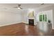Open living room featuring hardwood floors, a fireplace, and access to the outdoors at 3992 Camden Way, Alpharetta, GA 30005