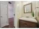 Stylish powder room featuring a modern vanity, decorative mirror, and elegant fixtures at 3992 Camden Way, Alpharetta, GA 30005