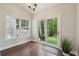 Bright sun room with hardwood floors, large windows, and sliding glass doors to the backyard at 3992 Camden Way, Alpharetta, GA 30005