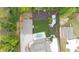 An aerial shot of the backyard featuring a pool, outbuilding, lawn, and lush landscaping at 604 Trinity Church Rd, Canton, GA 30115