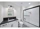Bathroom with a white vanity and black countertop and shower with a tub at 604 Trinity Church Rd, Canton, GA 30115