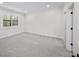Spacious bedroom with bright light, a window with blinds, and neutral-toned carpet at 604 Trinity Church Rd, Canton, GA 30115