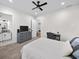 Spacious bedroom with neutral colors, carpeted floors, television, and an ensuite bathroom at 604 Trinity Church Rd, Canton, GA 30115