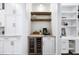 Charming butler pantry with wine storage and floating shelves and countertop appliances at 604 Trinity Church Rd, Canton, GA 30115