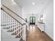 Bright entryway with hardwood floors and a staircase leading upstairs at 604 Trinity Church Rd, Canton, GA 30115