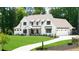 Charming two-story home with a well manicured lawn and an attached three car garage at 604 Trinity Church Rd, Canton, GA 30115