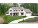 Stunning two-story home with a manicured lawn and elegant white facade at 604 Trinity Church Rd, Canton, GA 30115