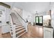 Elegant foyer with hardwood floors, staircase, and stylish double doors at 604 Trinity Church Rd, Canton, GA 30115