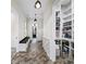 Charming hallway featuring herringbone floors, a built-in bench, and access to a pantry at 604 Trinity Church Rd, Canton, GA 30115