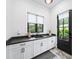 Bright laundry room with ample counter space, a dark sink, and a door to the backyard at 604 Trinity Church Rd, Canton, GA 30115