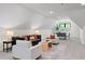 Bright bonus room with vaulted ceiling, featuring a seating area and dining area at 604 Trinity Church Rd, Canton, GA 30115