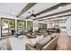 Open-concept living room featuring exposed beams, a fireplace, and views of the pool at 604 Trinity Church Rd, Canton, GA 30115