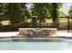 Close-up of a custom pool with a stone spa and waterfall feature at 604 Trinity Church Rd, Canton, GA 30115