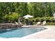 Luxurious pool area with a tanning ledge, stone accents, and lounge seating at 604 Trinity Church Rd, Canton, GA 30115