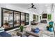 Inviting outdoor patio featuring stone floors, comfortable seating, and sliding glass doors to the home's interior at 604 Trinity Church Rd, Canton, GA 30115