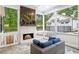 Cozy screened-in porch with brick fireplace and comfortable seating at 604 Trinity Church Rd, Canton, GA 30115