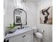 Chic half bathroom with stylish mirror, white vanity, and elegant decor at 604 Trinity Church Rd, Canton, GA 30115