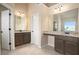 Bright bathroom featuring dual vanities with granite countertops and ample lighting at 113 Osier Dr, Mcdonough, GA 30252
