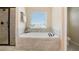 Bright bathroom boasting a soaking tub, separate glass-enclosed shower, and tile accents at 113 Osier Dr, Mcdonough, GA 30252