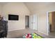 Well-lit bedroom featuring a bed, TV and ample natural light at 113 Osier Dr, Mcdonough, GA 30252