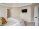 Spacious bedroom with neutral walls, carpet flooring, ceiling detail, and TV at 113 Osier Dr, Mcdonough, GA 30252