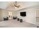 Open bedroom featuring plush seating, modern TV, and contemporary design creating a relaxing living space at 113 Osier Dr, Mcdonough, GA 30252