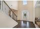 Bright foyer with gleaming hardwood floors, staircase, and natural light at 113 Osier Dr, Mcdonough, GA 30252