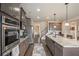 Modern kitchen with stainless steel appliances, granite countertops, and large island at 113 Osier Dr, Mcdonough, GA 30252