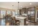 Open-concept kitchen boasts granite counters, modern appliances, and breakfast bar at 113 Osier Dr, Mcdonough, GA 30252
