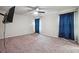 Bedroom featuring plush carpet, modern ceiling fan, and good natural light from windows with dark blue curtains at 1340 Delo Ln, Cumming, GA 30041