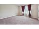Bedroom featuring carpet, neutral walls, and natural light from a window with decorative curtains at 1340 Delo Ln, Cumming, GA 30041