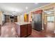 Open-concept kitchen with stainless steel appliances and an island, flowing into the living area at 1340 Delo Ln, Cumming, GA 30041