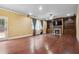 Spacious living room featuring hardwood floors, a fireplace, and built-in shelving at 1340 Delo Ln, Cumming, GA 30041