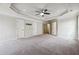 Expansive main bedroom with tray ceilings, plush carpet, and ensuite bathroom access at 1340 Delo Ln, Cumming, GA 30041