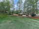 Picturesque backyard featuring a lush green lawn, mature trees, and a putting green at 139 Grandmar Chase, Canton, GA 30115