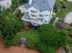 Aerial view of a backyard with a deck, lush landscaping, and a patio area at 139 Grandmar Chase, Canton, GA 30115