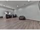 Open basement area with vinyl flooring, recessed lighting, and multiple seating areas for entertaining at 139 Grandmar Chase, Canton, GA 30115