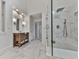 Bright bathroom featuring marble tile, a glass-enclosed shower, and a stylish wooden vanity at 139 Grandmar Chase, Canton, GA 30115