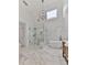 Bathroom features a glass shower, tub, modern vanity, and marble tile flooring for a bright and elegant touch at 139 Grandmar Chase, Canton, GA 30115