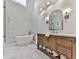 Modern bathroom with a standalone tub, glass shower, and wooden vanity at 139 Grandmar Chase, Canton, GA 30115