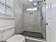 Sleek bathroom features a glass shower with gray tile surround and black honeycomb tile floor at 139 Grandmar Chase, Canton, GA 30115