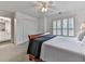 Well-lit bedroom features carpet, a ceiling fan, shutter-style blinds, and a Primary bathroom at 139 Grandmar Chase, Canton, GA 30115