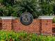Elegant brick sign for Woodmont Golf and Country Club with beautiful landscaping and greenery at 139 Grandmar Chase, Canton, GA 30115