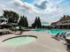 Resort-style community pool area with lounge chairs, umbrellas, and a hot tub, creating an inviting recreational space at 139 Grandmar Chase, Canton, GA 30115